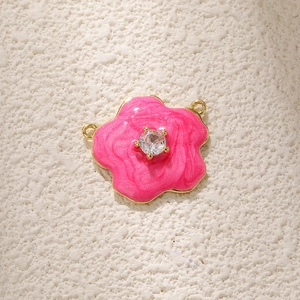 Macro view of pink tulip flower pendant with gold plating and cubic zirconia inlay