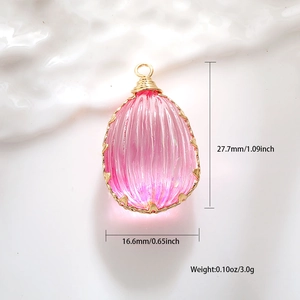 Macro detail of teardrop pink resin pendant with gold wire-wrapped edges and dimensions