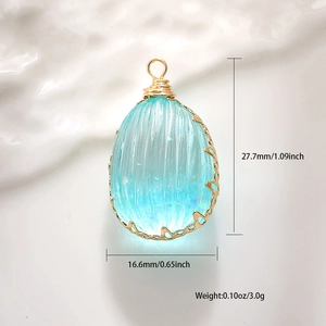 Detailed view of blue dried flower pendant with dimensions 27.7mm by 16.6mm