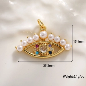 Detail shot of eye-shaped gold pendant with colorful zircons and pearls, 25x15mm