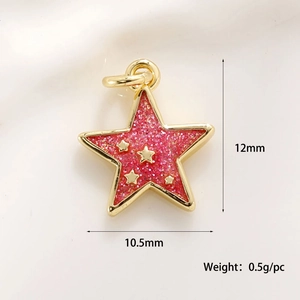 Macro shot of 12mm gold star pendant with red glitter inlay and small star accents