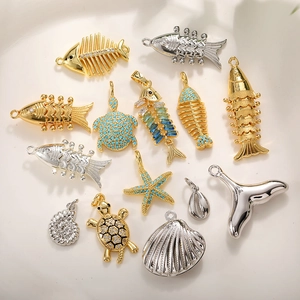 Marine themed 14k gold plated koi fish and sea turtle pendants with turquoise stones