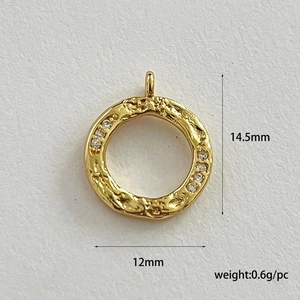 Detailed macro view of a hammered gold charm with zircon stones for DIY jewelry