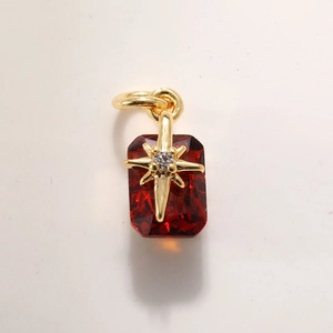 Macro detail of hexagonal star gold pendant with rectangle red gemstone and micro-diamond