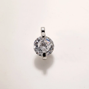 Macro view of a circular crystal pendant with gold plating and faceted hexagon star cut