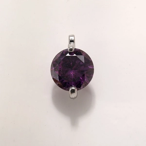 Detail of a round deep purple crystal pendant with silver plated metal claw setting