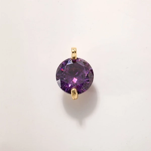 Detailed view of purple round crystal pendant with gold plating and dual hanging loops