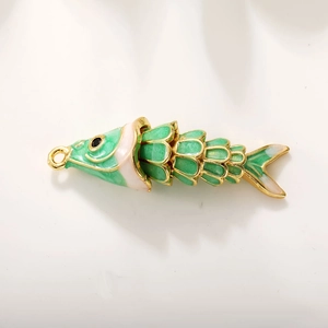 Macro shot of 18k gold plated green enamel koi fish charm with scale texture detail