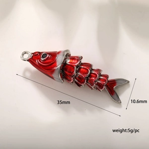 Detailed view of red enamel fish pendant with dimensions 35mm x 10.6mm and 5g weight