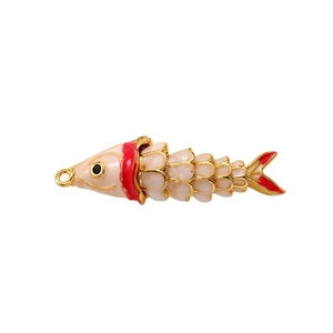 Articulated fish pendant in 18k gold plating with pink enamel and a 180-degree view