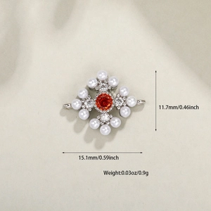 Macro view of silver star jewelry charm with red gemstone and pearls, 15mm size details