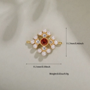 Detailed view of flower pendant with orange gem, white pearls and zircon accents