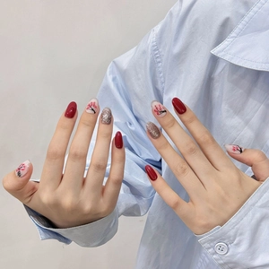 Handmade press-on nails with plum blossom art in wine red and silver glitter