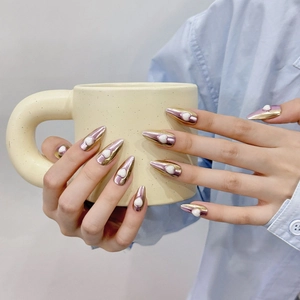 Metallic stiletto press-on nails with 3D heart charms and golden purple chrome finish
