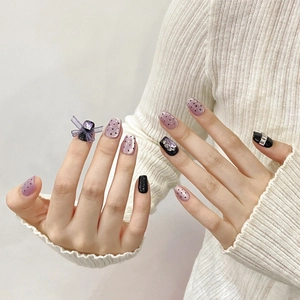 Purple cat eye press-on nails with 3D ribbon bows and sparkling rhinestones