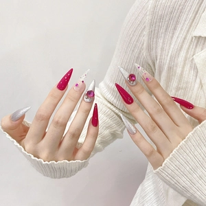 Handmade stiletto press-on nails with pink gems and silver glitter for luxury manicure