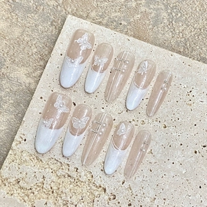 Handmade nude french butterfly press-on nails with pearls and glitter on long oval tips