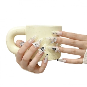 Handmade press-on nails with white lace, 3D bows, and silver beads on long pointed tips