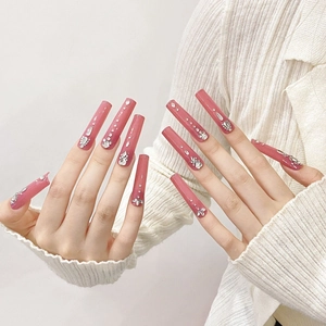Long square soft pink press-on nails with silver rhinestones and glitter flower art