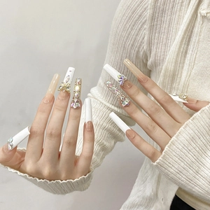 Handmade extra-long press-on nails with white coffin design, 3D crystals and butterflies