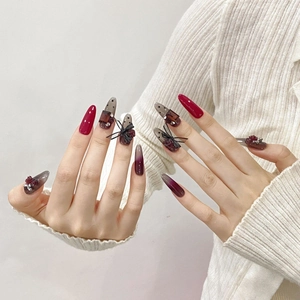 Handmade press-on nails featuring red rose reliefs, black bows, and polka dot lace designs