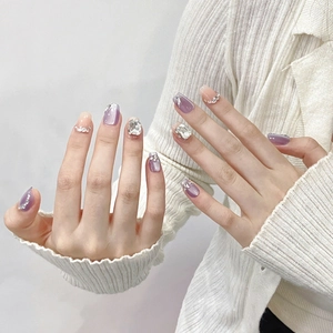 Handmade purple cat-eye press-on nails with sparkling rhinestones and gradient finish