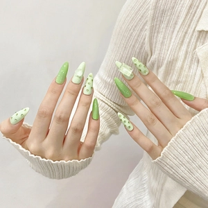 Handmade green press-on nails in almond shape with 3D sugar cube and rhinestone accents