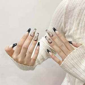 Hand-painted butterfly coffin press-on nails with black tips and gold stud accents