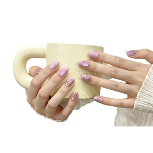 Elegant purple cat eye press-on nails with floral patterns and glitter finish