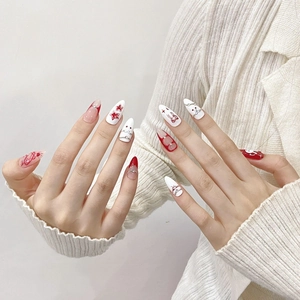 Handmade almond press-on nails featuring cute red rabbits, stars, and cherry nail art designs