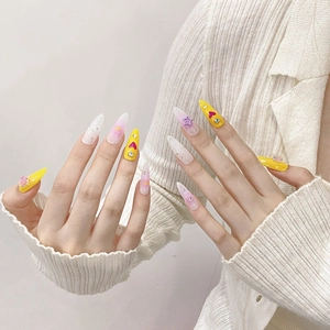 Handmade press-on nails with ice-clear lollipop stars and heart charms on long stiletto tips
