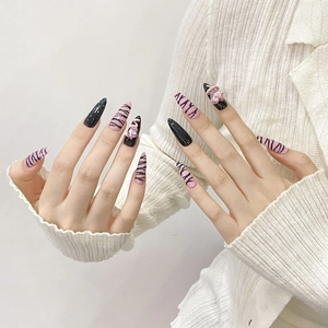 Handmade pink and black zebra pattern stiletto press-on nails with 3D heart charms