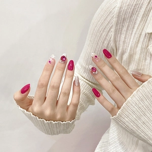 Handmade magenta press-on nails with silver glitter and large rhinestone accents