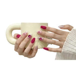Handmade magenta and silver glitter press-on nails with large pink rhinestones