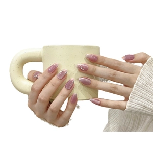Handmade cat eye press-on nails in lavender purple with glitter and rhinestones