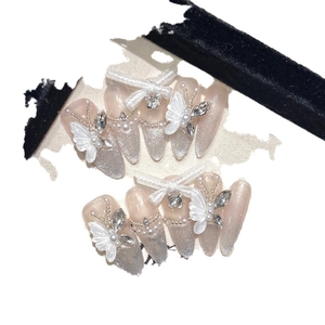 Handmade almond press-on nails with white butterflies and cat-eye glitter finish
