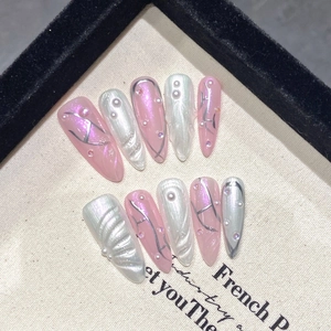 Pink cat eye stiletto press-on nails with H letter design, pearls, and rhinestones