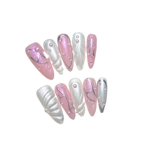 Pink and white cat eye press-on nails with silver H design, pearls and rhinestones