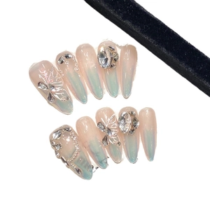 Handmade aurora butterfly press-on nails with 3D crystals and pearl accents in long stiletto