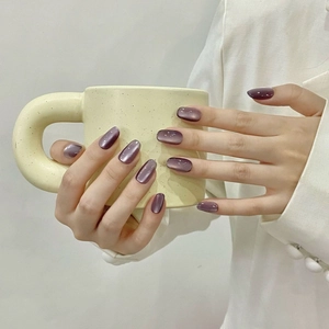 Translucent purple cat eye press-on nails with glossy finish shown on hands
