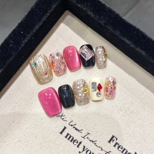 Handmade cat-eye press-on nails with luxury gemstones and diamonds in vintage neon style