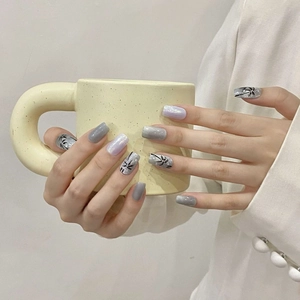 Handmade cat eye press-on nails with purple glitter and hand-painted palm tree designs