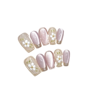 Pink cat-eye handmade press-on nails with white flower patterns and golden edges