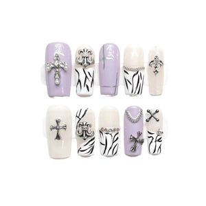 Lavender and zebra print press-on nails with silver cross accents and crystal studs