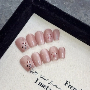 Handmade cat eye press-on nails in nude pink with 3D paw and bear art designs