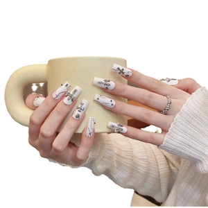 White marble press-on nails with silver cross accents and steel beads in long square shape