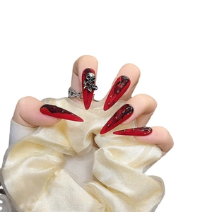 Extra long stiletto press-on nails with red and black marble gothic skull design