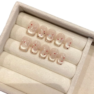 French retro cat eye press-on nails with colorful polka dots in a velvet storage box