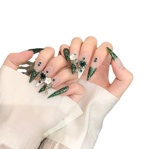 Handmade emerald green stiletto press-on nails with 3D white flowers and gemstones