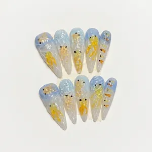Handmade stiletto press-on nails with blue marble texture and hand-painted gold fish design